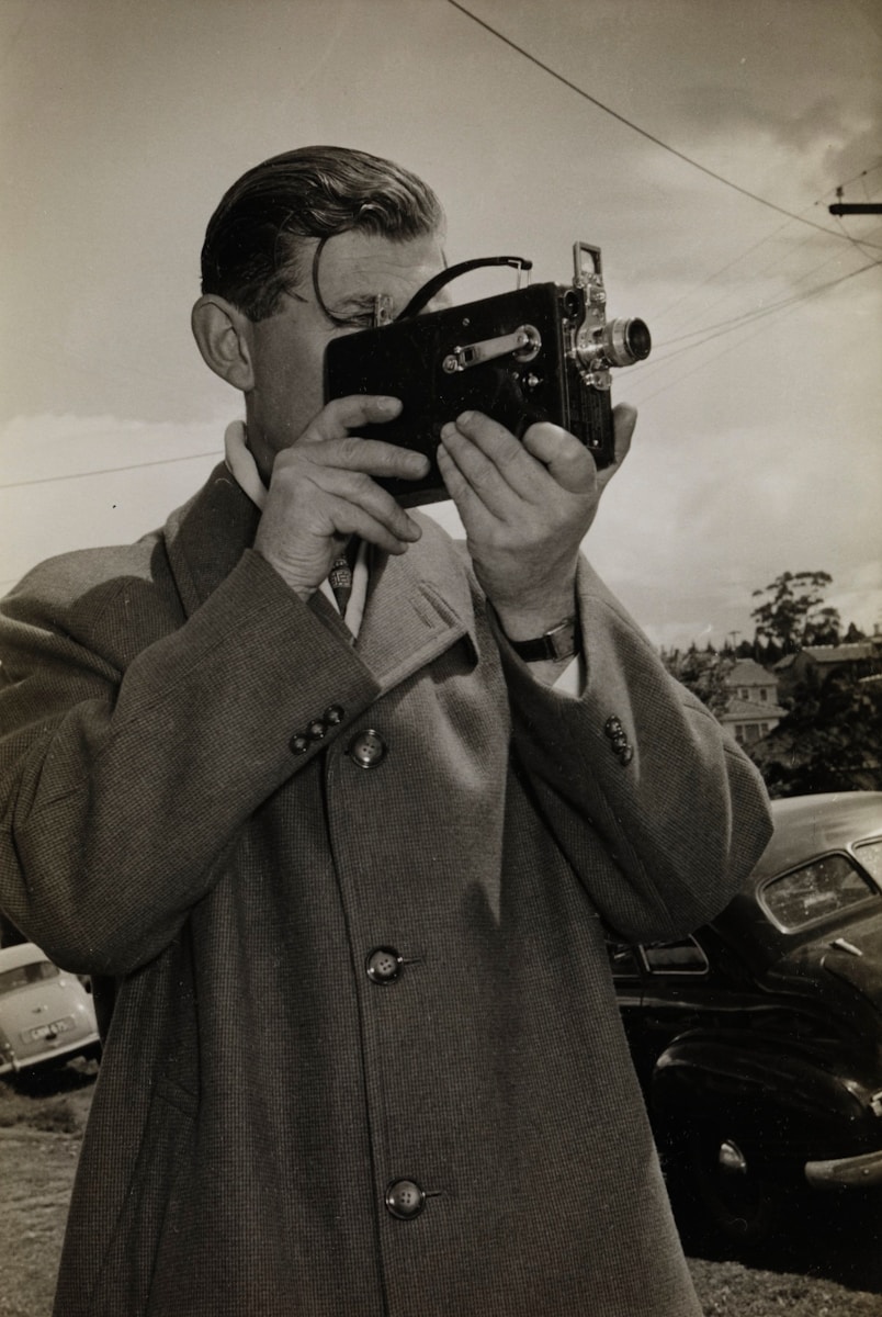 man holding black camera